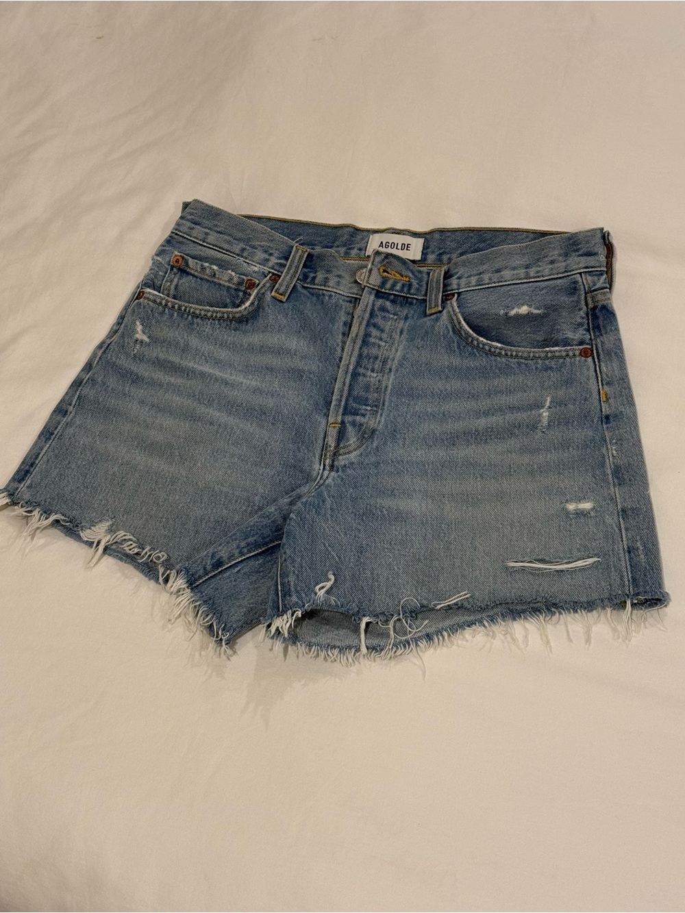 Agolde light wash distressed denim cutoff shorts